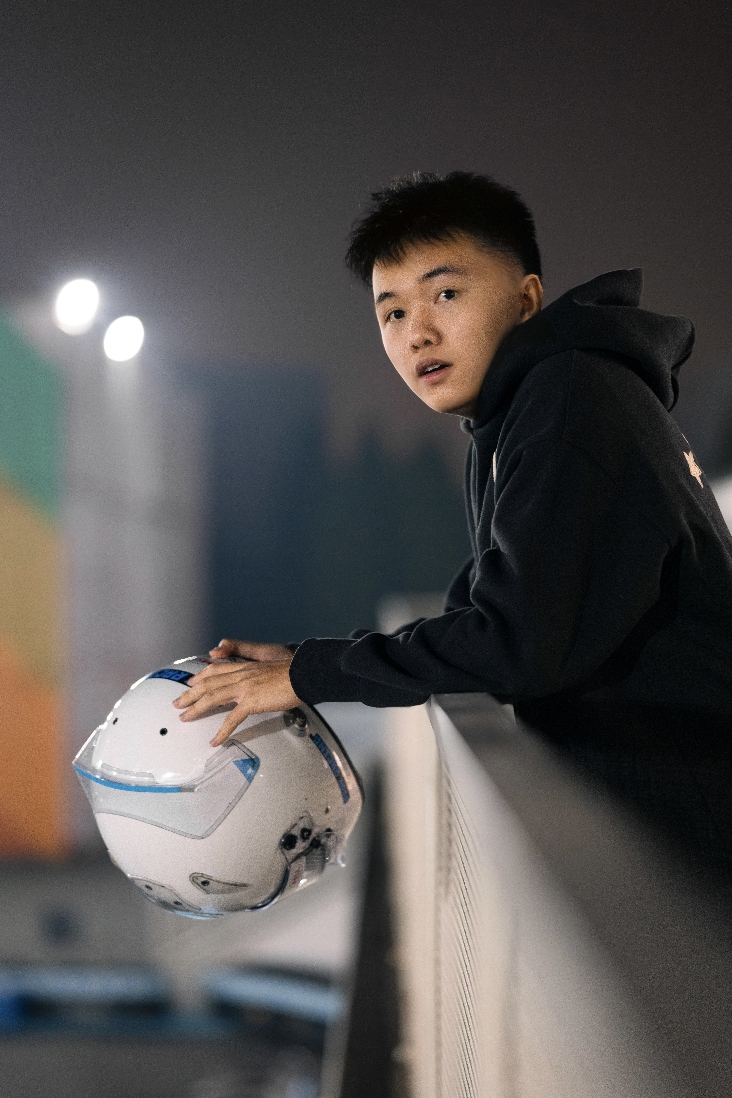 Leaning over a railing with a soccer ball